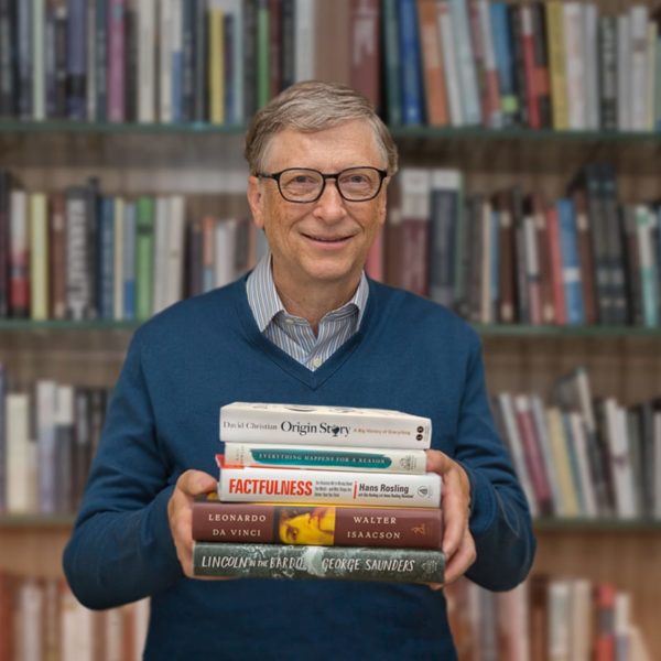 Bill Gates holding books